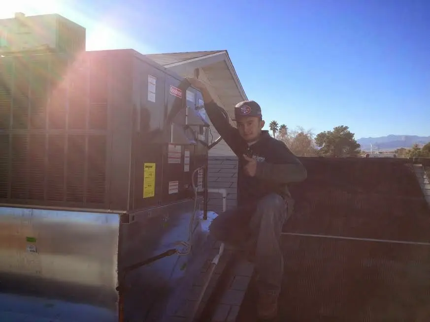 HVAC technician performing HVAC Inspection on a rooftop unit in Snellville